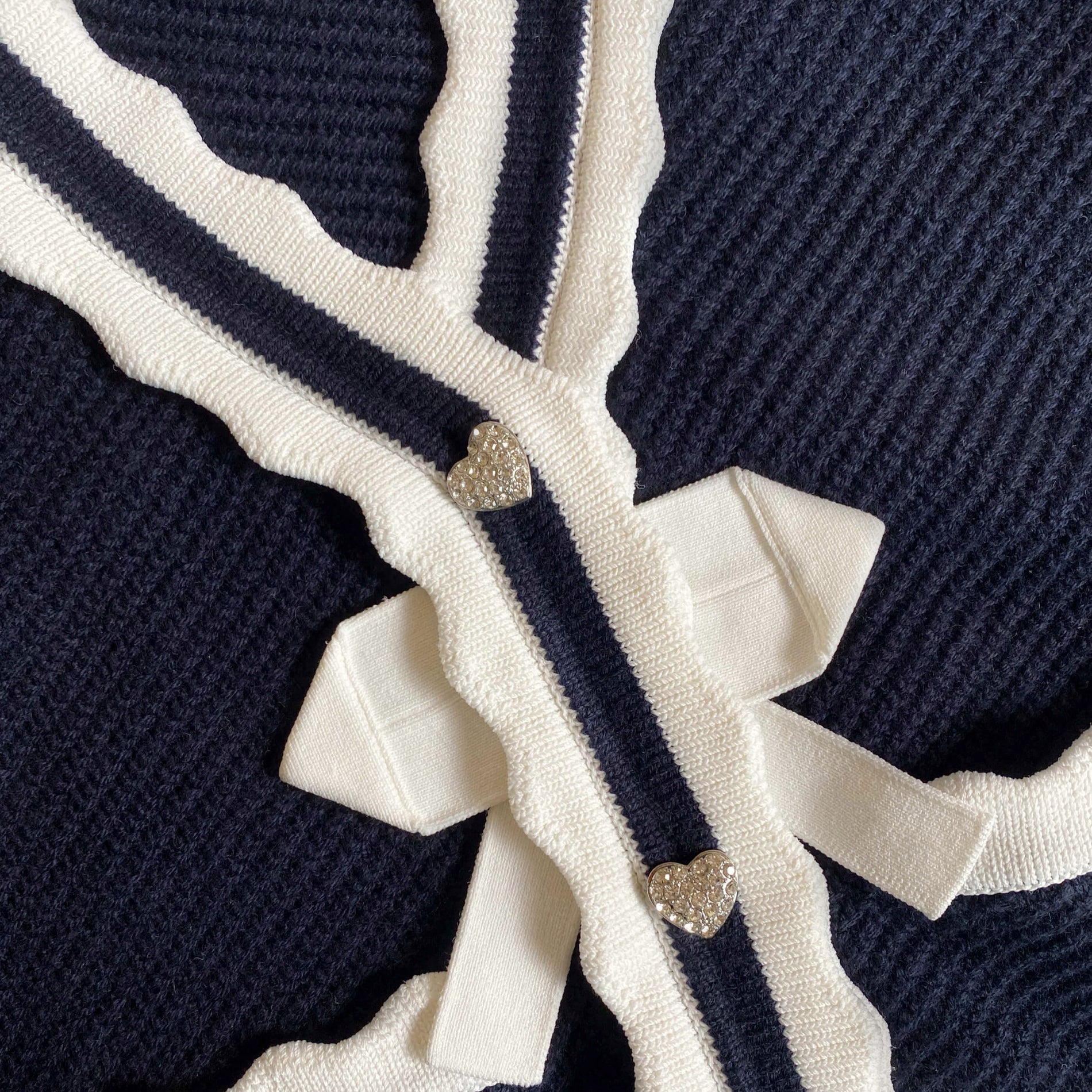 A close up of the fabric for the Navy Knit  Bow Cardigan