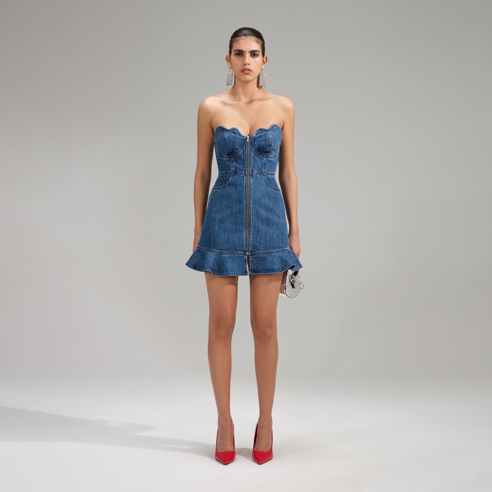 A woman wearing the Bandeau Denim Mini Dress With Scalloped Edge