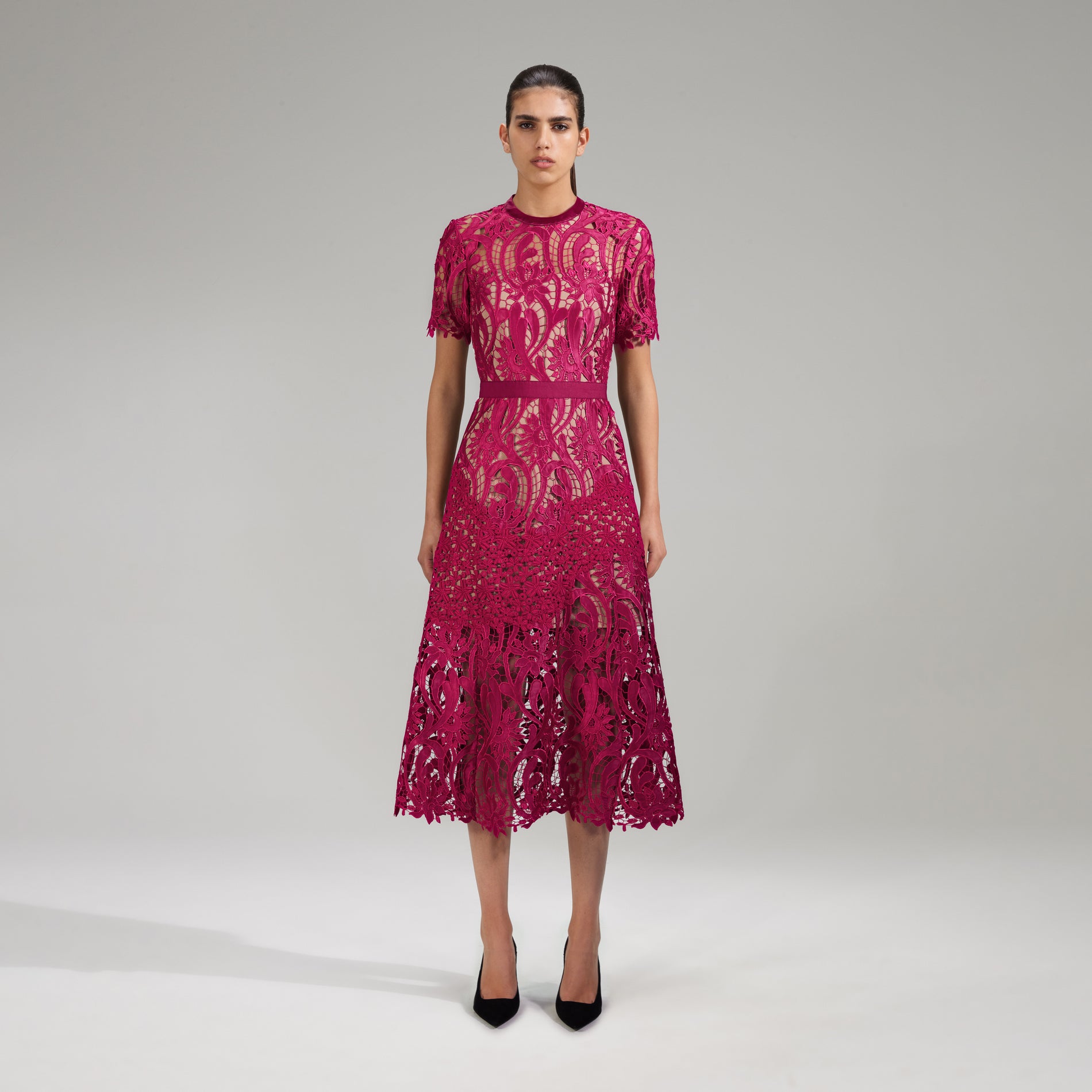 A woman wearing the Burgundy Floral Lace Midi Dress