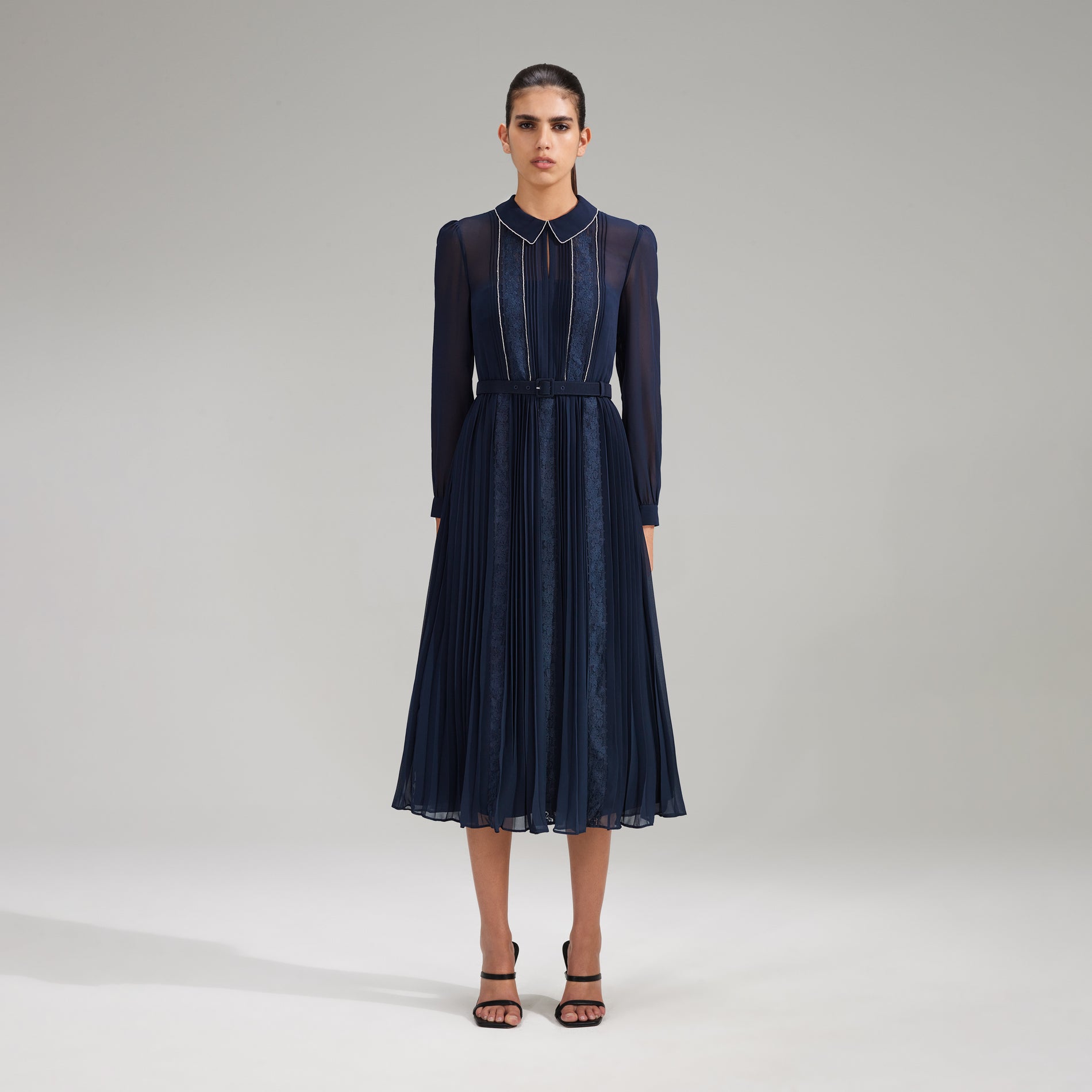 A woman wearing the Navy Pleated Diamante Detail Midi Dress