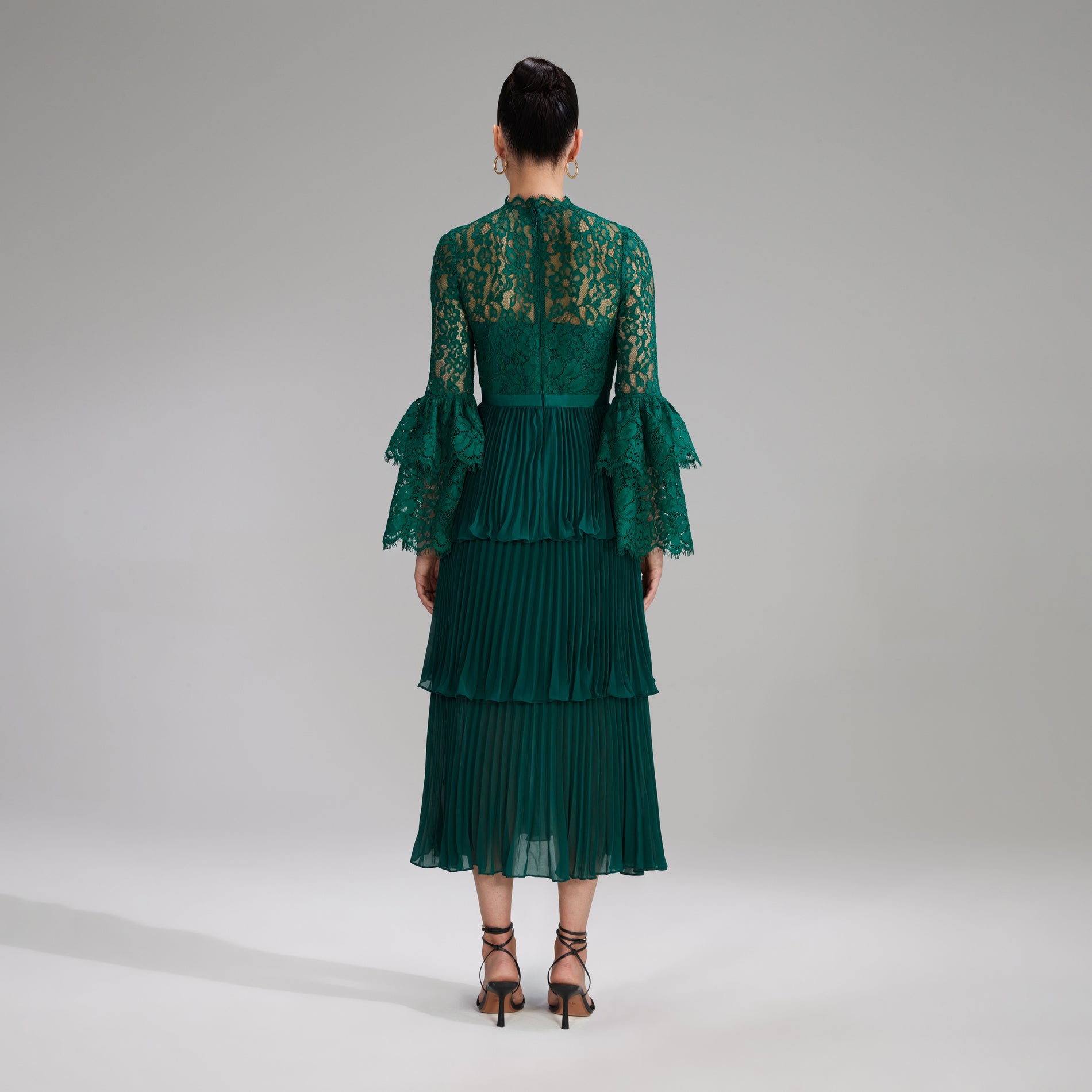 A woman wearing the Green Cord Lace Tiered Midi Dress