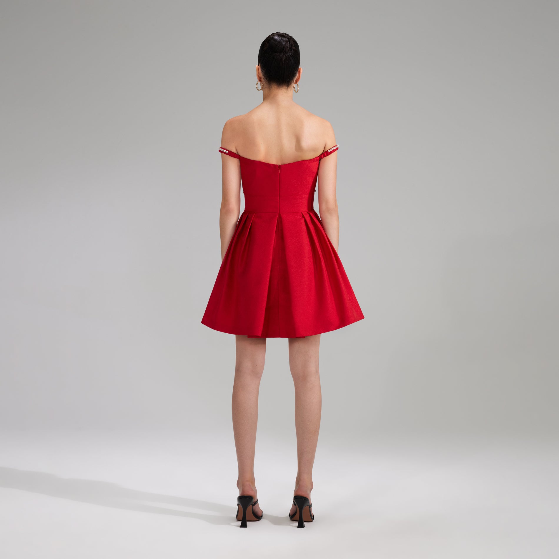 A woman wearing the Red Textured Diamante Detail Mini Dress