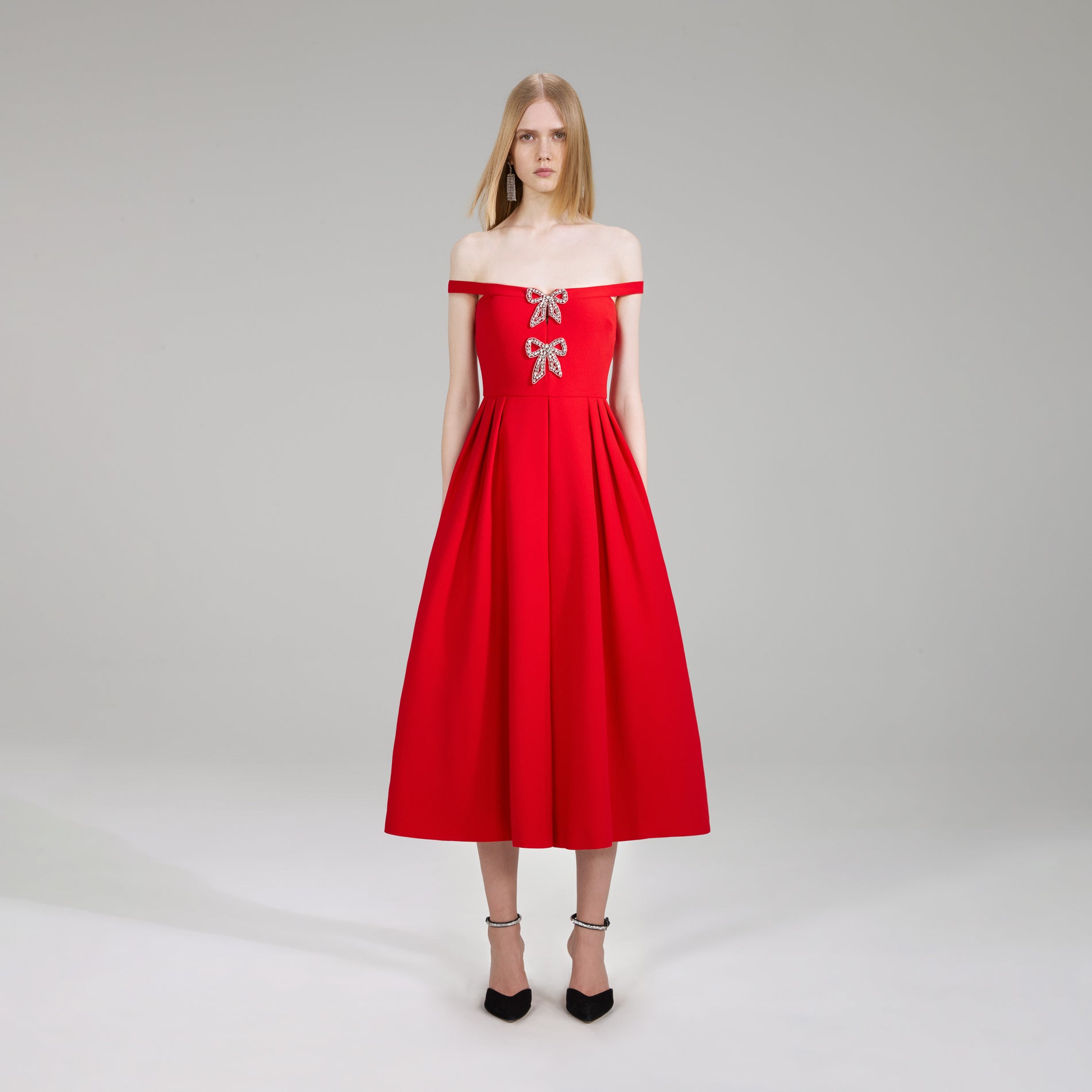 A woman wearing the Red Crepe Bow Midi Dress