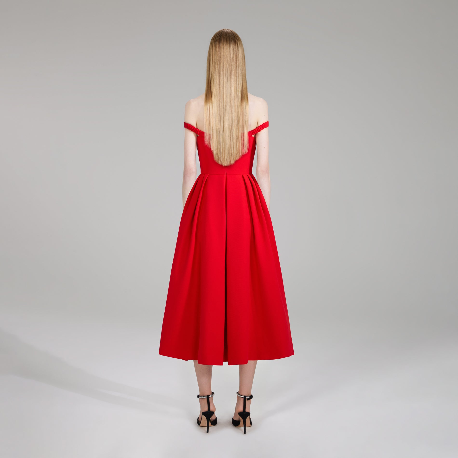 A woman wearing the Red Crepe Bow Midi Dress