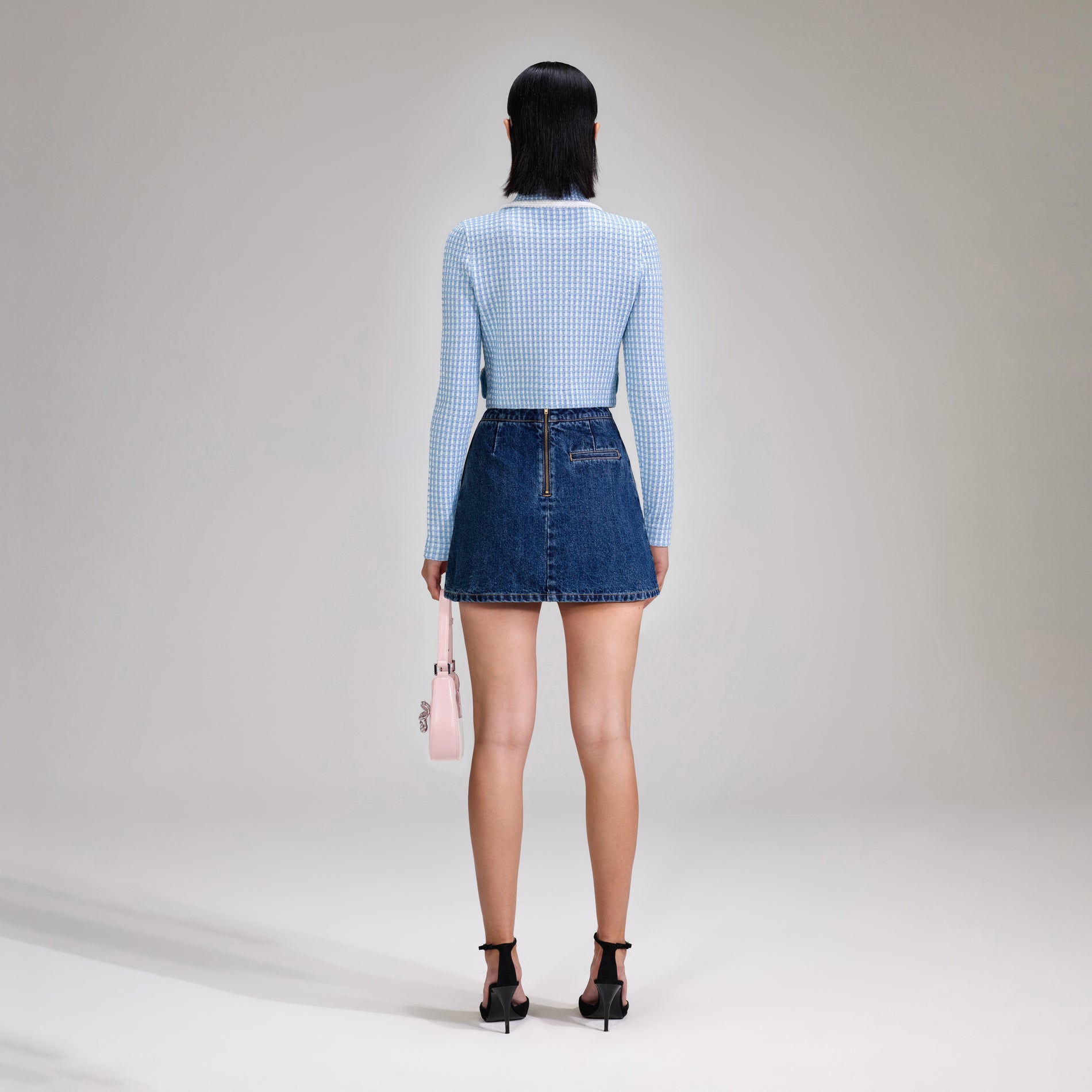 A woman wearing the Blue Lurex Knitted Cardigan
