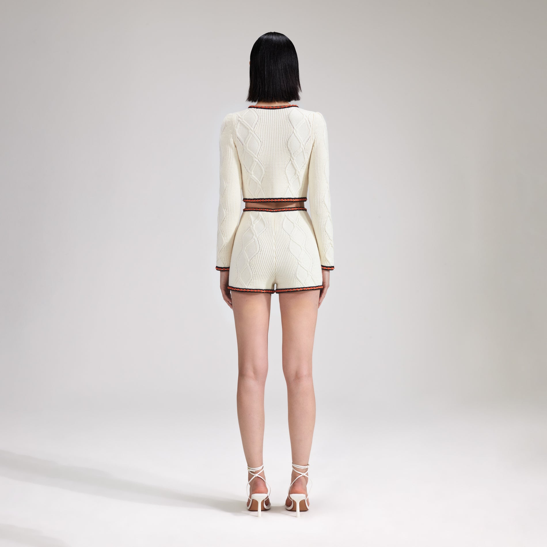 A woman wearing the Cream Cable Knit Short