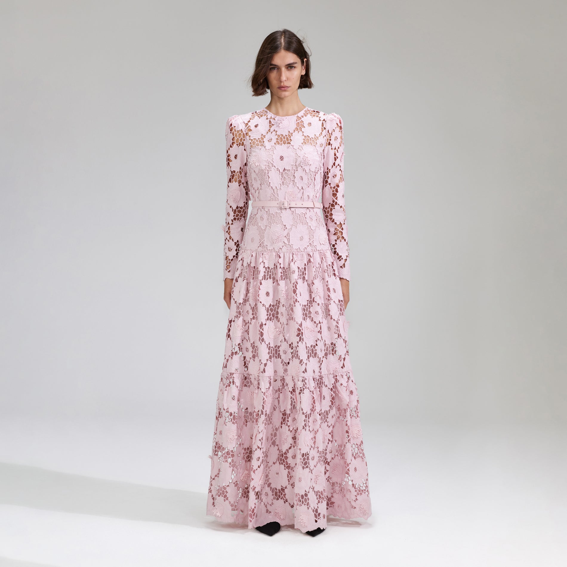 A woman wearing the Pink 3D Cotton Lace Maxi Dress