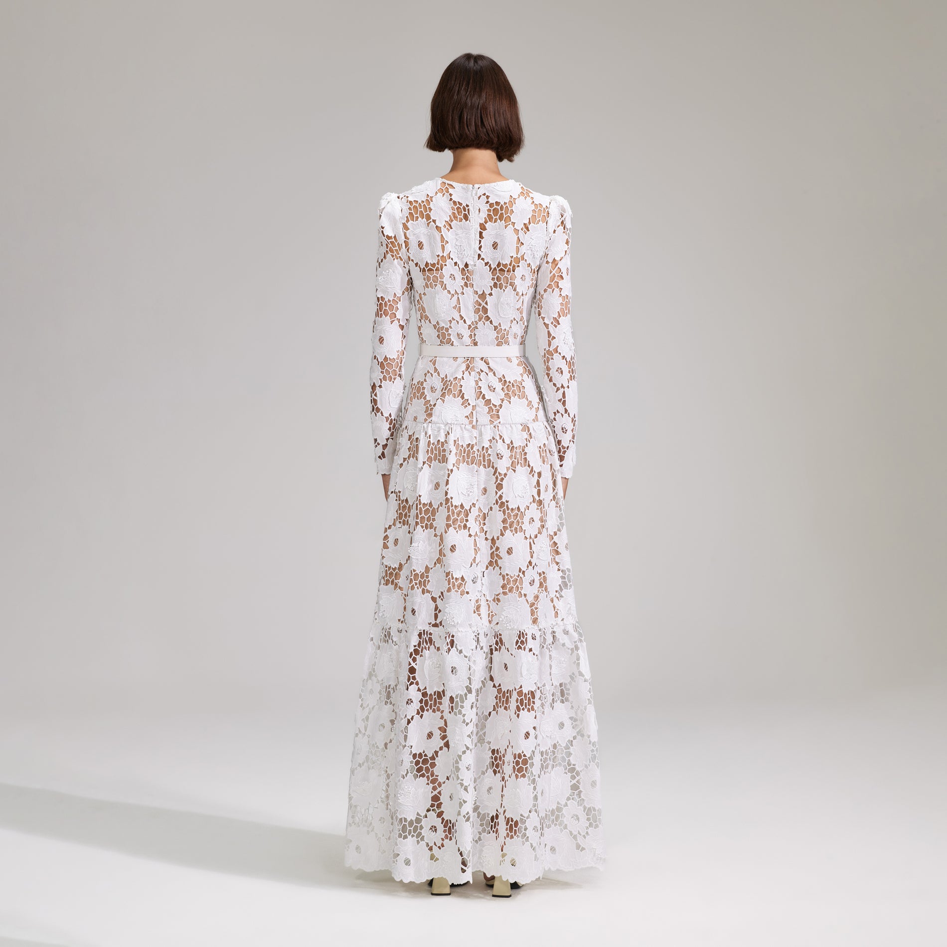 A woman wearing the White 3D Cotton Lace Maxi Dress