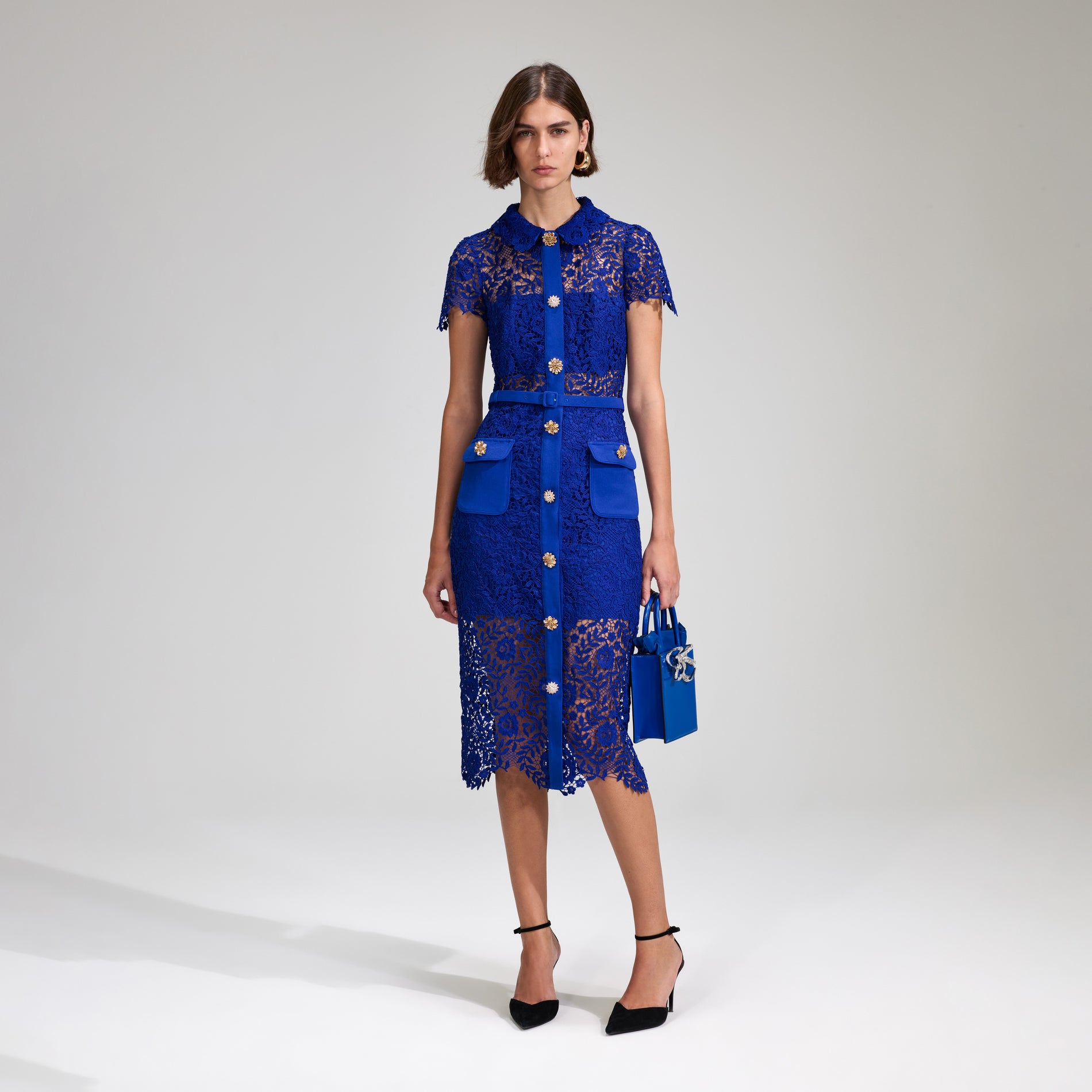 A woman wearing the Cobalt Rose Lace Button Midi Dress