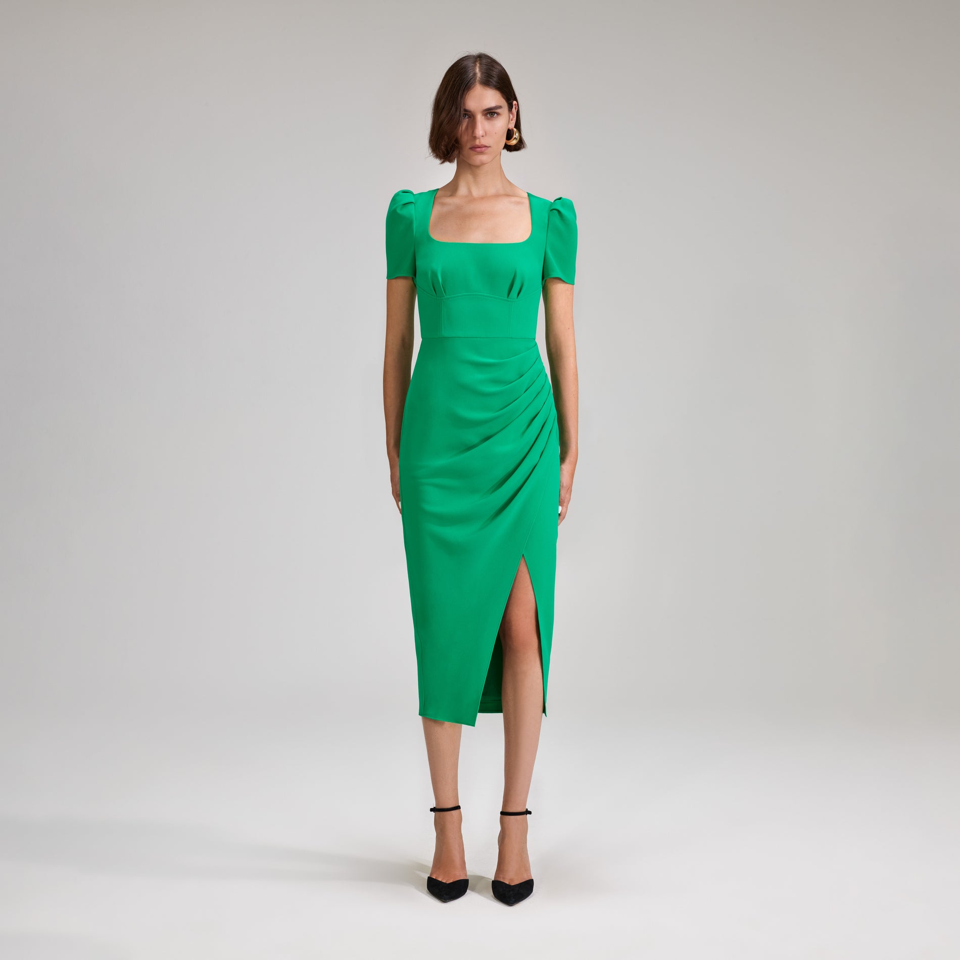 A woman wearing the Green Crepe Midi Dress