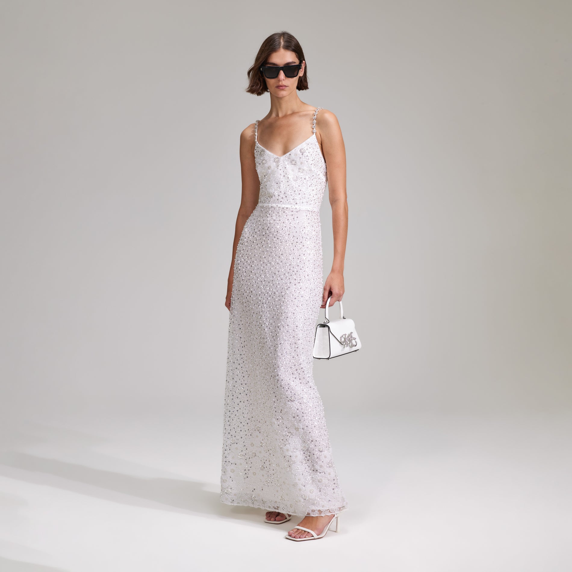 A woman wearing the White Beaded Sequin Maxi Dress