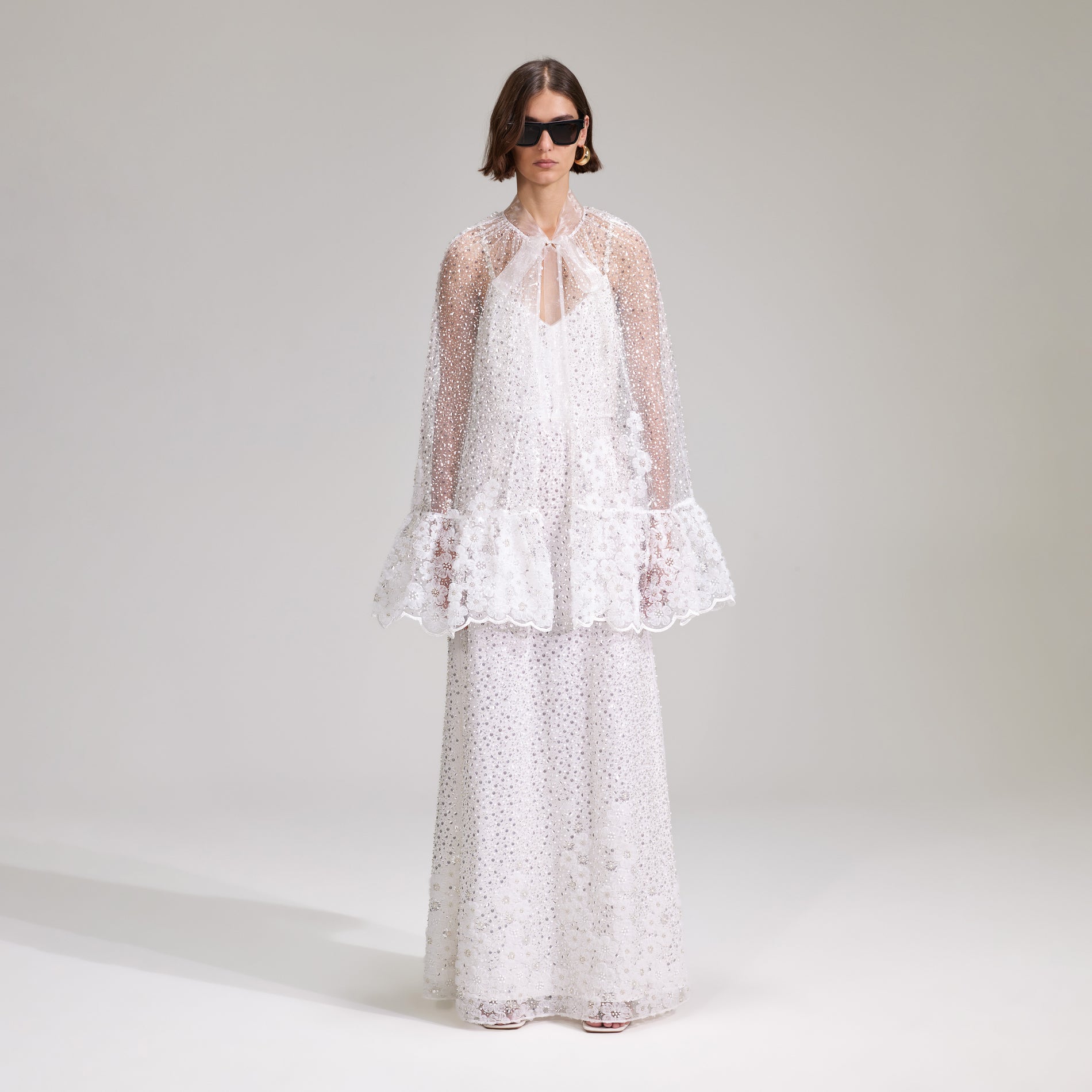 A woman wearing the White Beaded Sequin Mini Cape