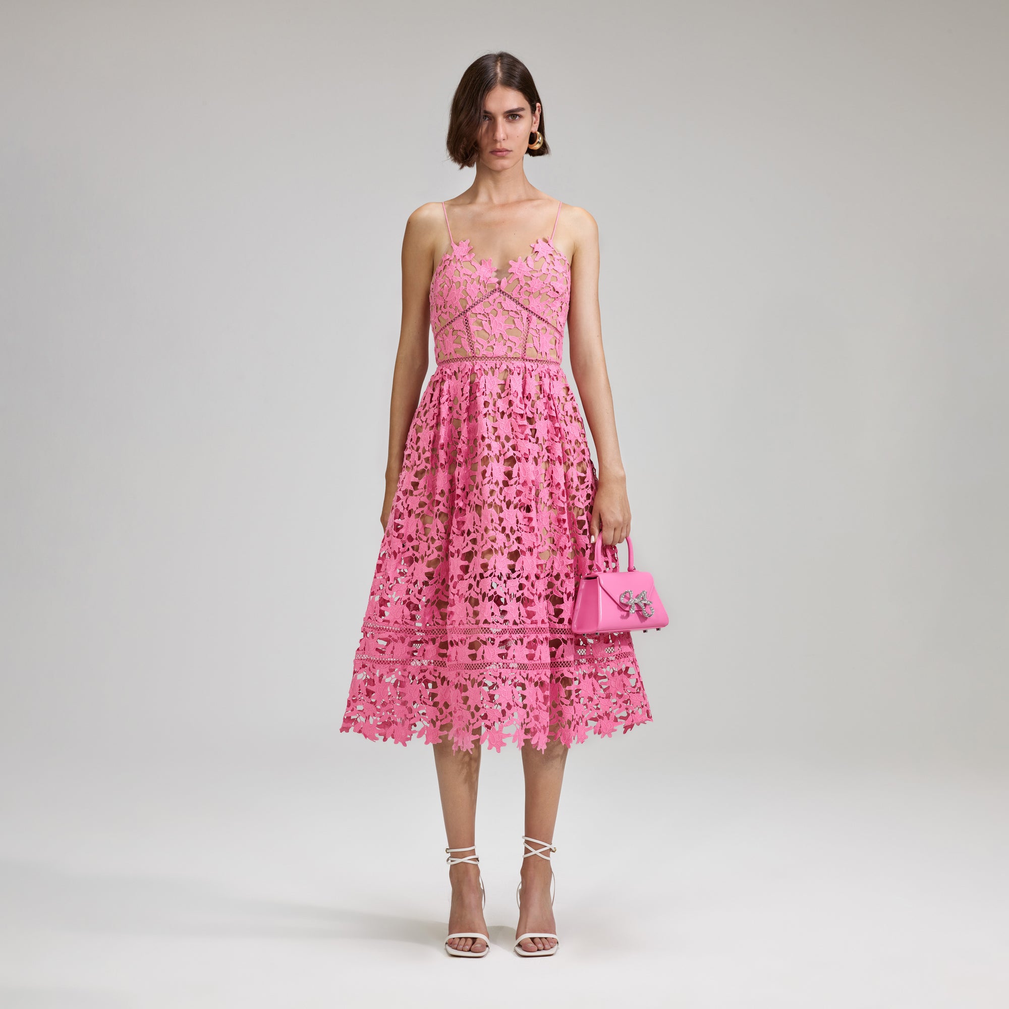 A woman wearing the Pink Azaelea Lace Midi Dress