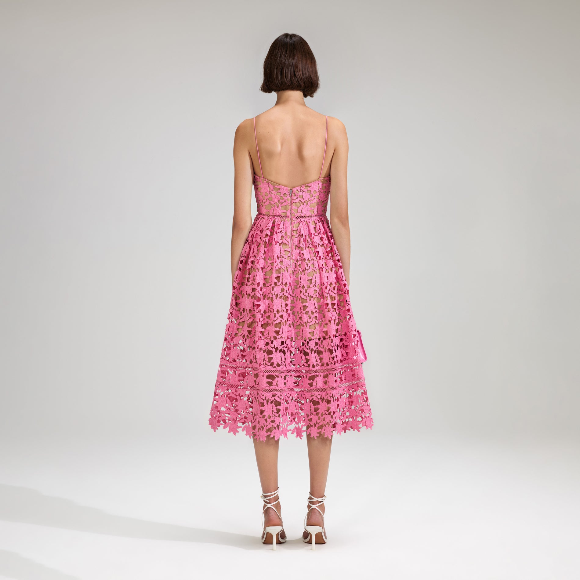A woman wearing the Pink Azaelea Lace Midi Dress