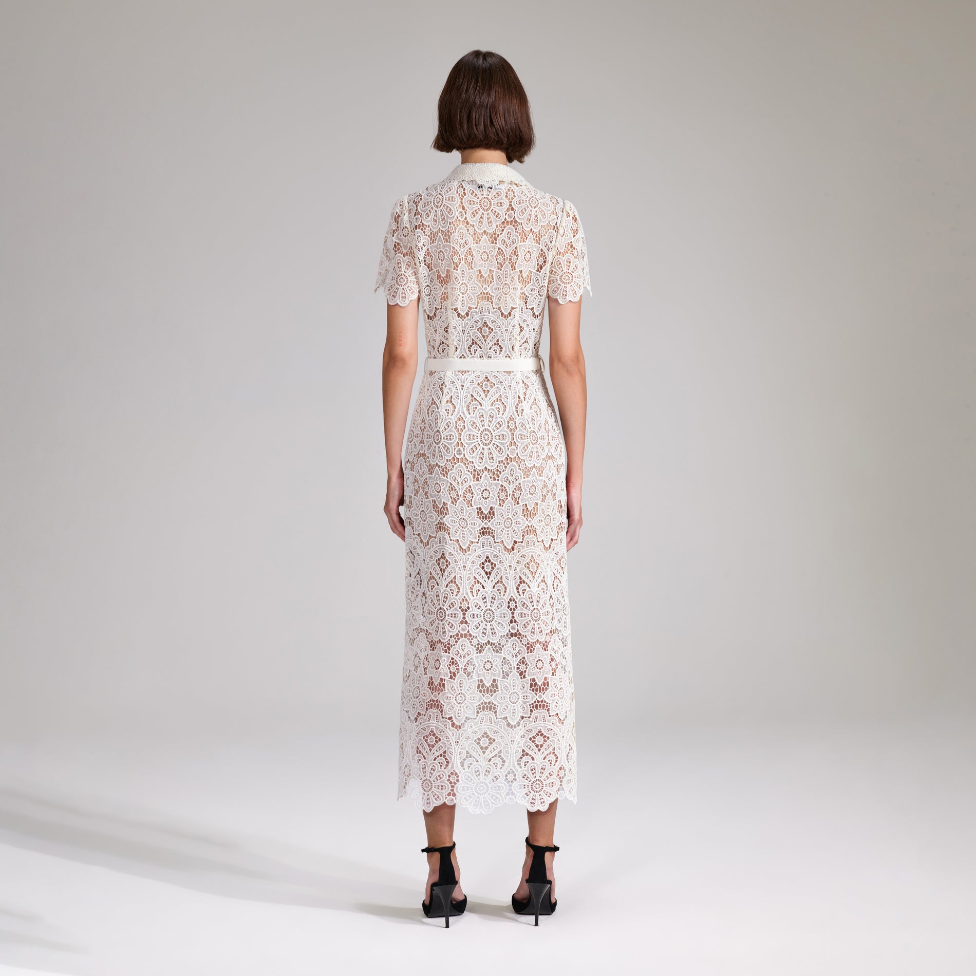 A woman wearing the Cream Floral Guipure Midi Dress