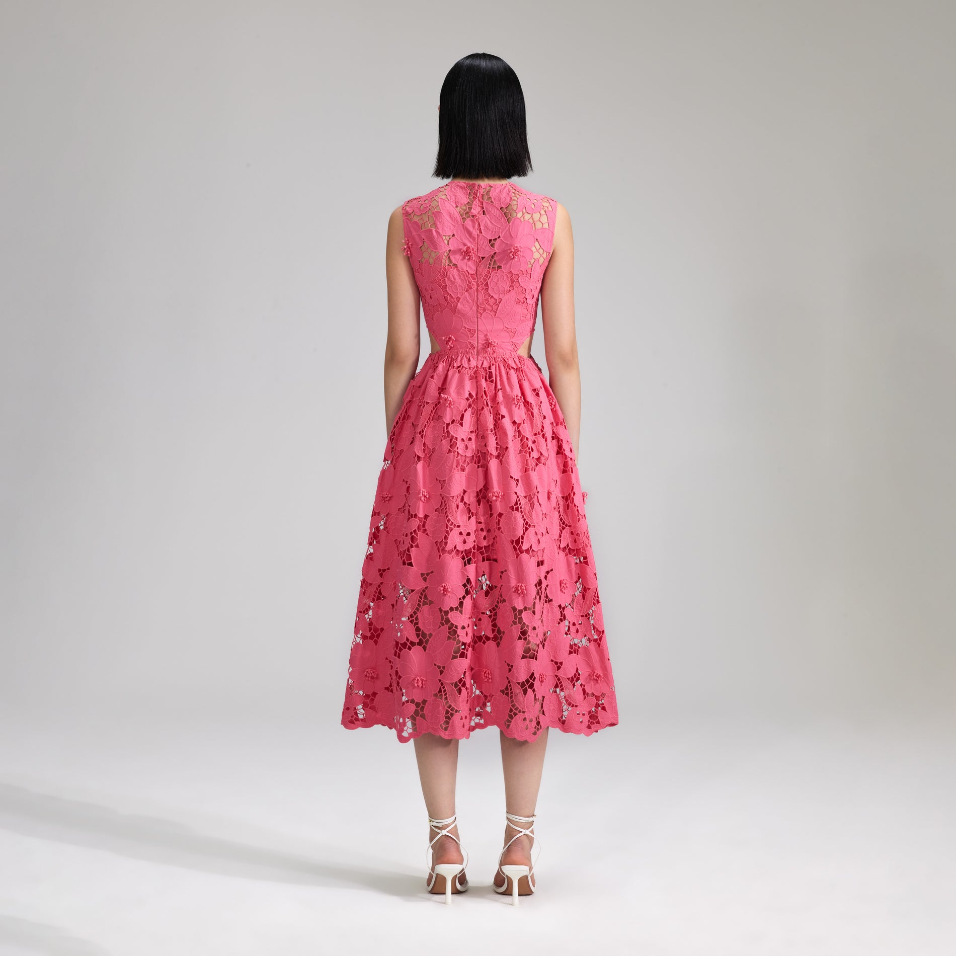 A woman wearing the Pink 3D Cotton Lace Midi Dress