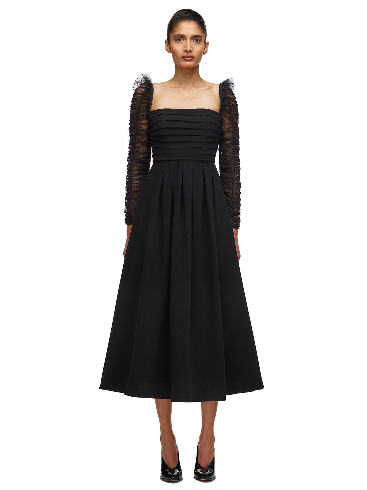A woman wearing the Crepe Dot Mesh Sleeved Midi Dress